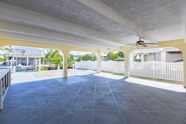 view of patio featuring ceiling fan and fence