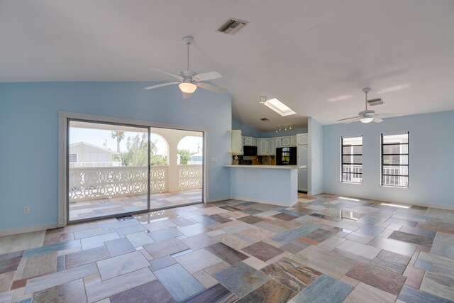 unfurnished living room featuring lofted ceiling, visible vents, and ceiling fan