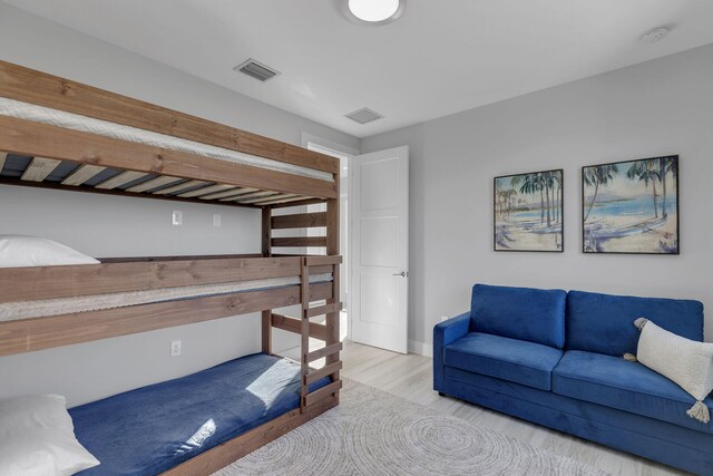 bedroom with visible vents and wood finished floors