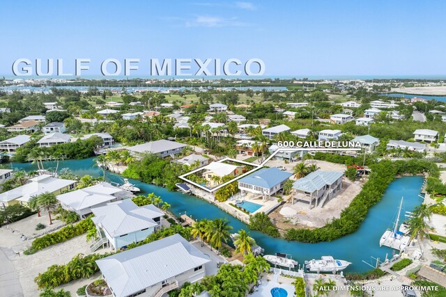 birds eye view of property with a water view and a residential view