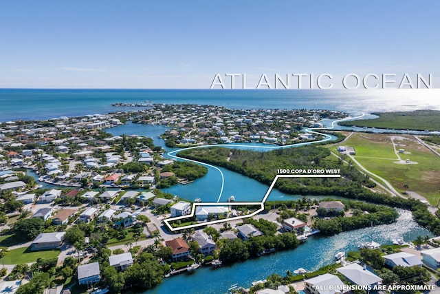 drone / aerial view featuring a water view and a residential view