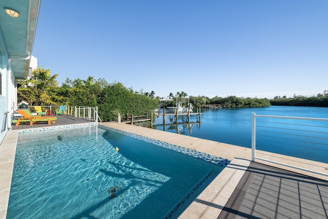 pool featuring a dock, a deck with water view, and boat lift