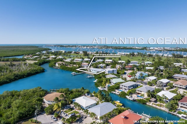 birds eye view of property featuring a water view and a residential view