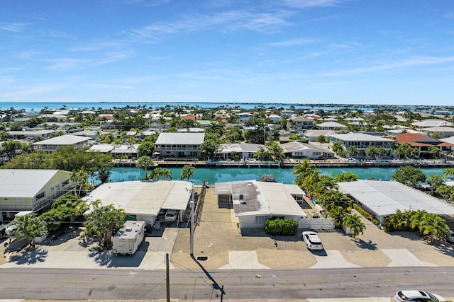 drone / aerial view with a water view and a residential view