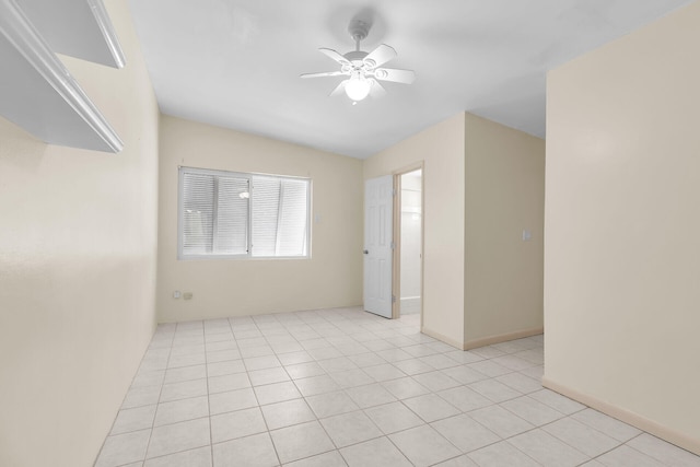 spare room with light tile patterned floors and a ceiling fan