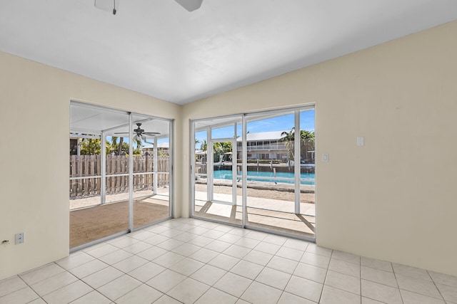 empty room with light tile patterned floors and ceiling fan