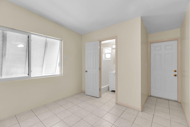 interior space featuring light tile patterned floors and a healthy amount of sunlight