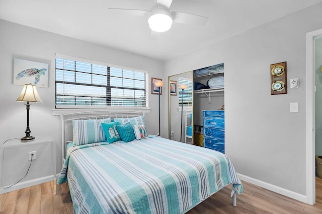 bedroom featuring a closet, baseboards, and wood finished floors