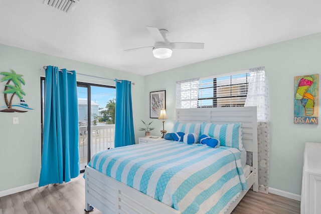 bedroom with access to exterior, visible vents, light wood-style floors, ceiling fan, and baseboards