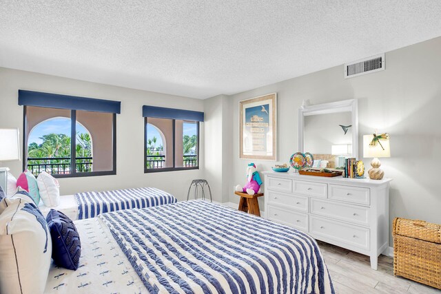 1001 Ocean Dr Unit 1-305, Key Colony, FL 33051 - bedroom with a textured ceiling