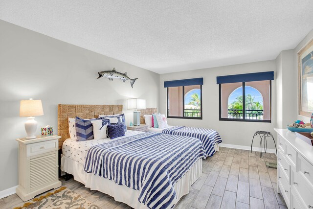 1001 Ocean Dr Unit 1-305, Key Colony, FL 33051 - bedroom with light wood-type flooring and a textured ceiling