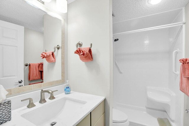 1001 Ocean Dr Unit 1-305, Key Colony, FL 33051 - bathroom featuring a textured ceiling, vanity, and a shower