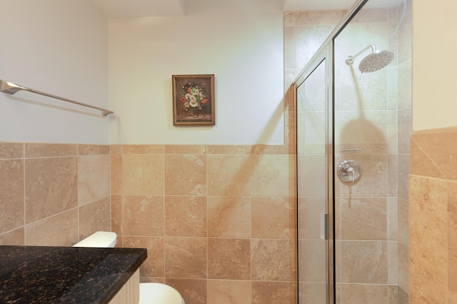 bathroom with toilet, tile walls, and a stall shower