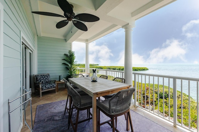 balcony with a water view and a ceiling fan