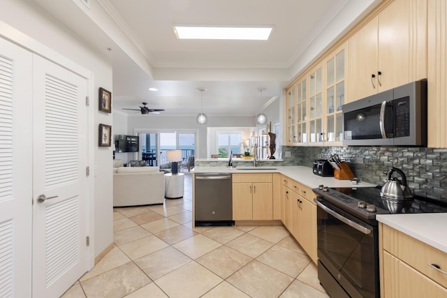 kitchen with light brown cabinetry, tasteful backsplash, a peninsula, open floor plan, and stainless steel appliances