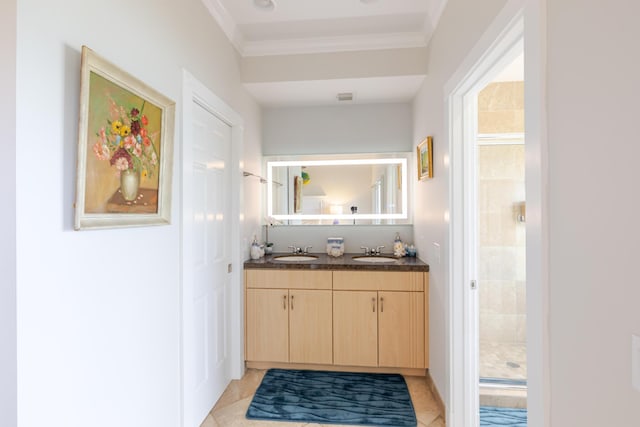 full bath featuring a sink, a shower stall, tile patterned floors, and ornamental molding