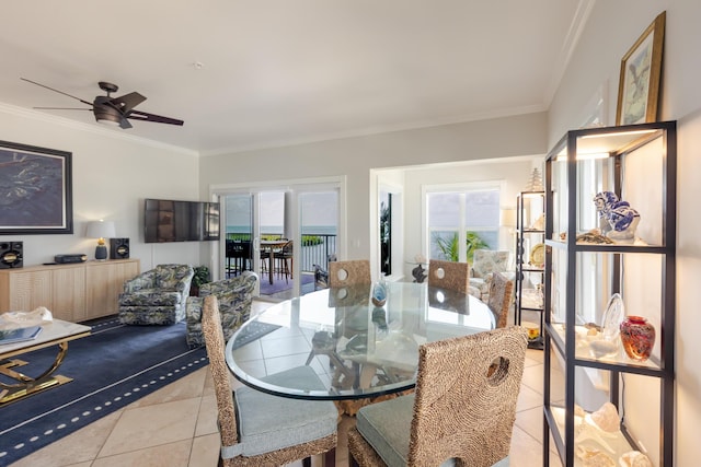 dining room with crown molding, ceiling fan, and light tile patterned flooring