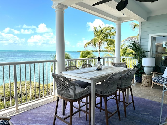 exterior space with a water view and ceiling fan