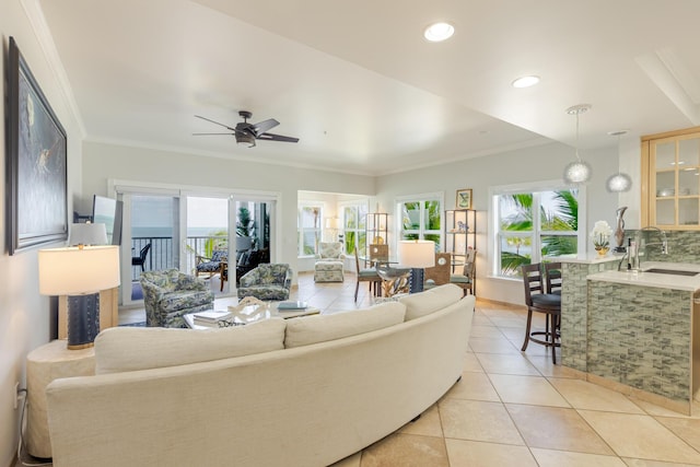 living area featuring light tile patterned floors, ornamental molding, recessed lighting, and ceiling fan