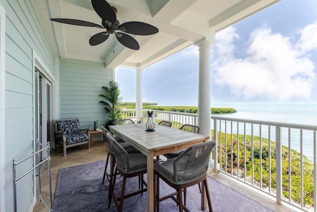 balcony featuring a ceiling fan and a water view