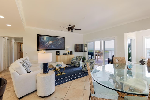 living area with ornamental molding, a ceiling fan, recessed lighting, and light tile patterned flooring