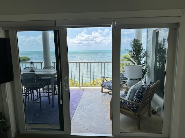 interior space with a water view and tile patterned floors