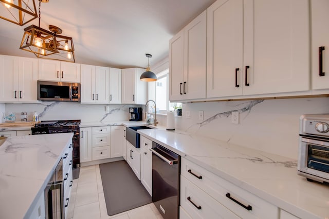 930 80th St, Marathon, FL 33050 - kitchen featuring stainless steel appliances, tasteful backsplash, white cabinets, and light stone countertops