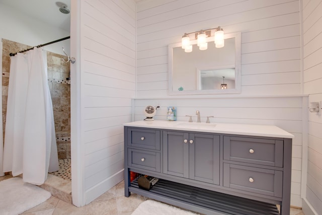 930 80th St, Marathon, FL 33050 - bathroom featuring tiled shower, vanity, wooden walls, and tile patterned flooring