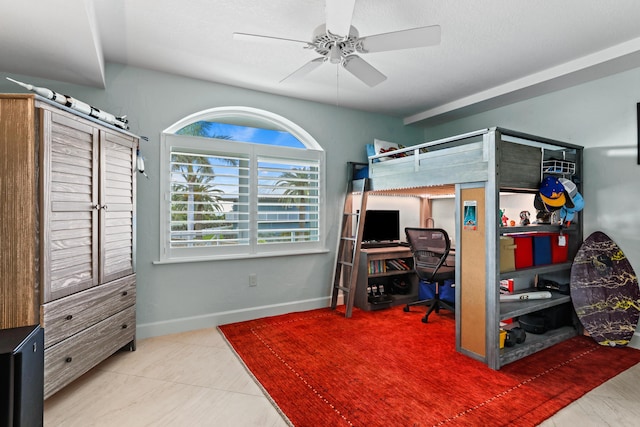 tiled bedroom with a textured ceiling and baseboards