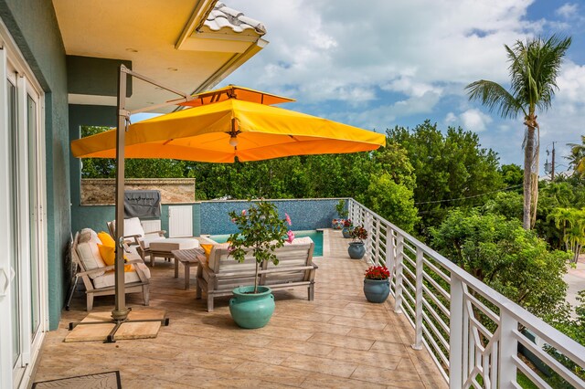 view of patio with outdoor lounge area and a balcony