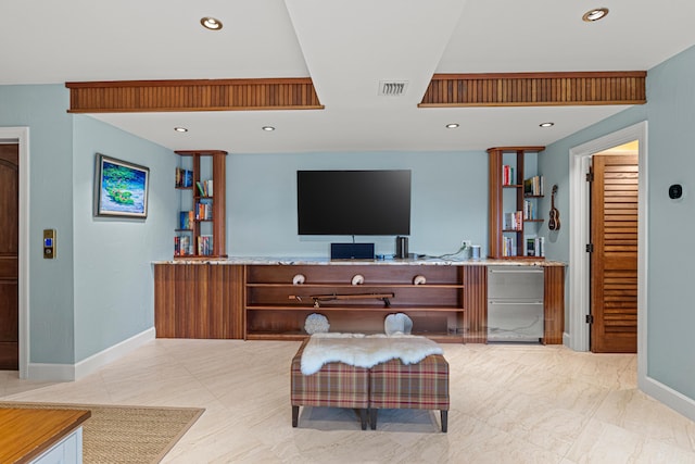 living room with baseboards, visible vents, and recessed lighting