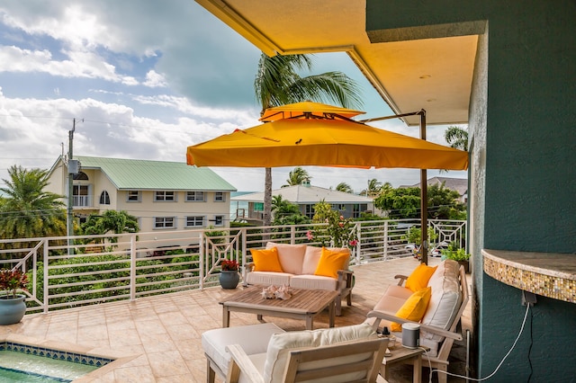 view of patio featuring a balcony and an outdoor living space