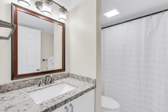 bathroom featuring toilet and vanity