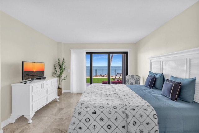 bedroom featuring access to exterior and baseboards
