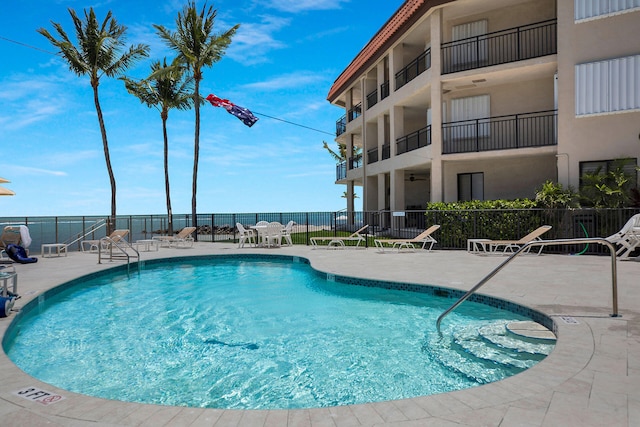 community pool featuring a patio area and fence