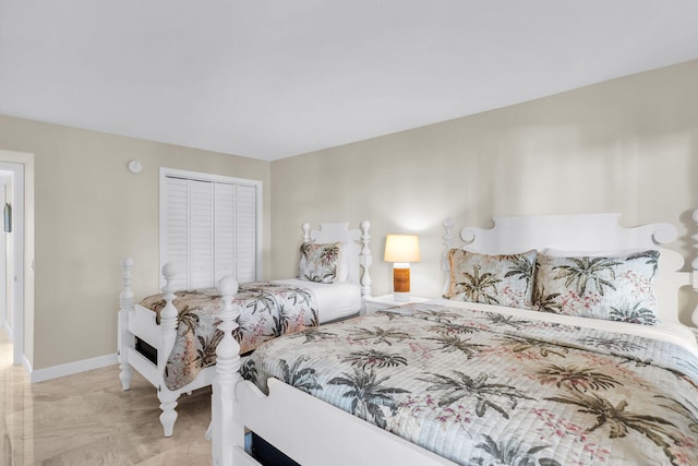 bedroom featuring a closet and baseboards