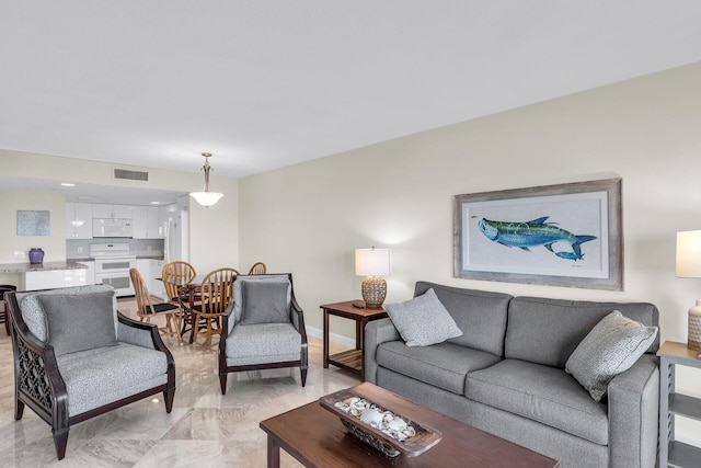 living room featuring baseboards and visible vents