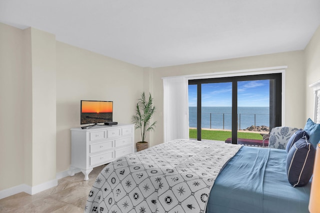 bedroom featuring access to outside and baseboards