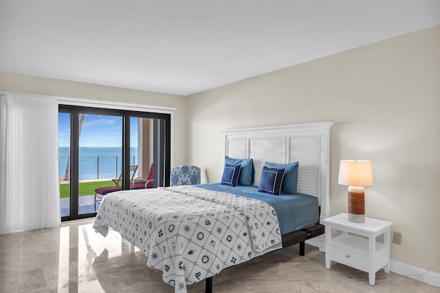 bedroom featuring a water view, access to exterior, and baseboards