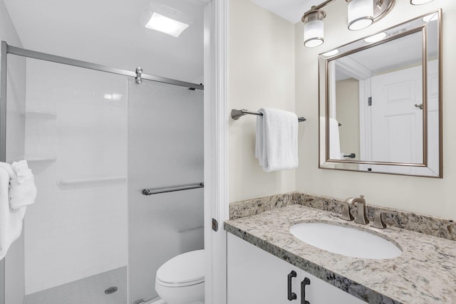 full bath with toilet, tiled shower, and vanity
