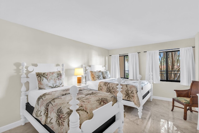 bedroom with marble finish floor and baseboards