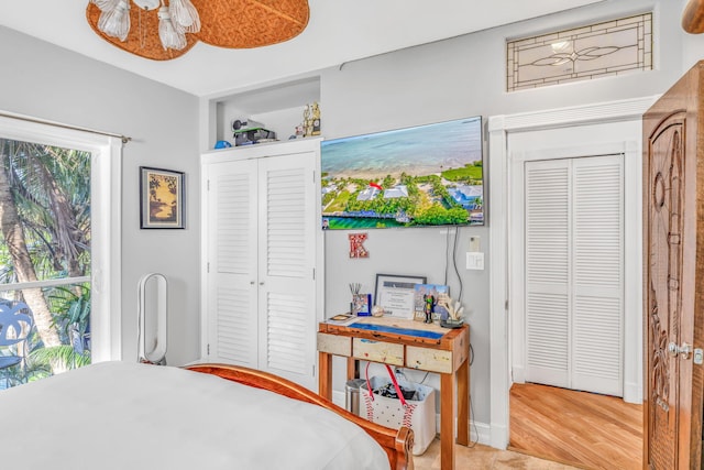 bedroom with baseboards and wood finished floors