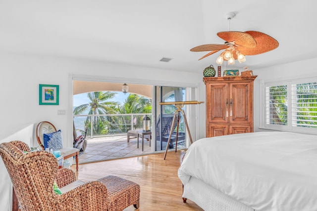 bedroom featuring light wood-style flooring, visible vents, and access to exterior