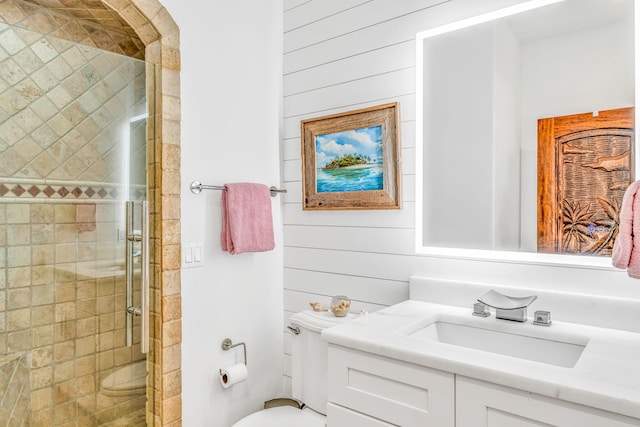 full bath featuring wood walls, a stall shower, vanity, and toilet