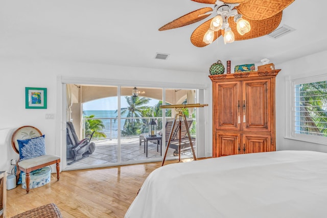 bedroom featuring light wood-type flooring, access to outside, visible vents, and ceiling fan