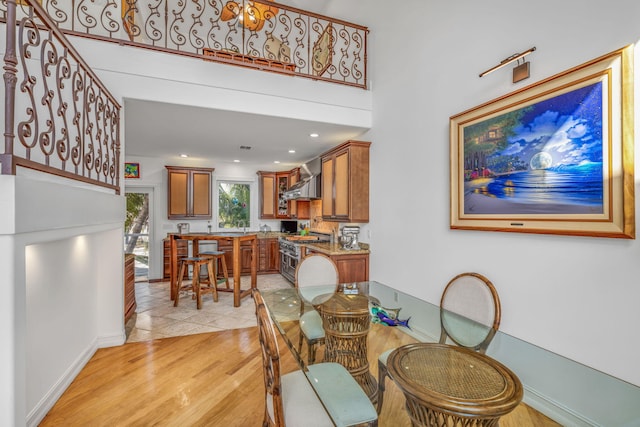 dining room featuring light wood finished floors and baseboards