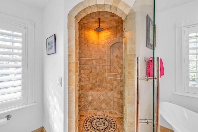 bathroom featuring a shower stall and a healthy amount of sunlight