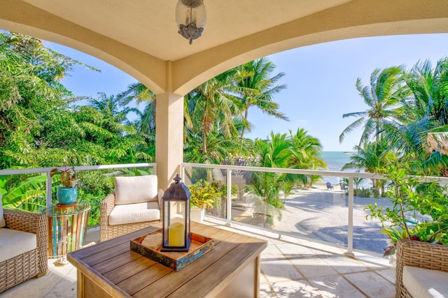 view of patio / terrace with a water view and a balcony