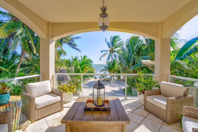 view of patio with a water view and a balcony