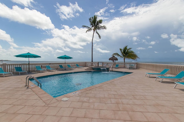 pool with a community hot tub and a patio